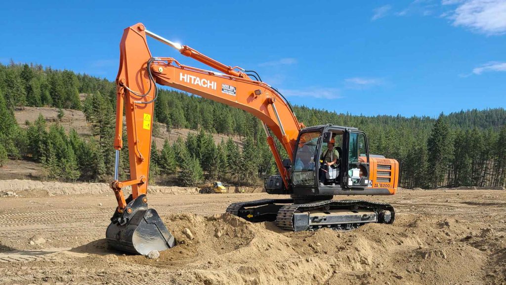 Heavy equipment operator using a Hitachi excavator